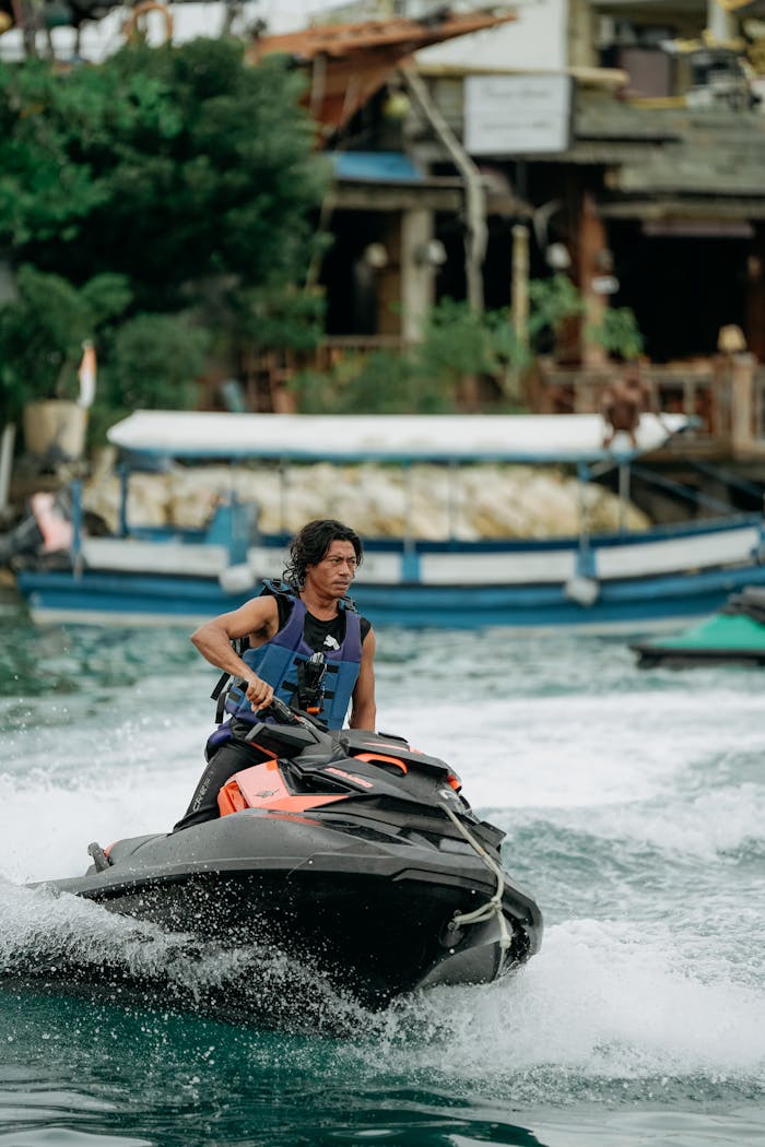 Man Riding Water Scooter near Seashore